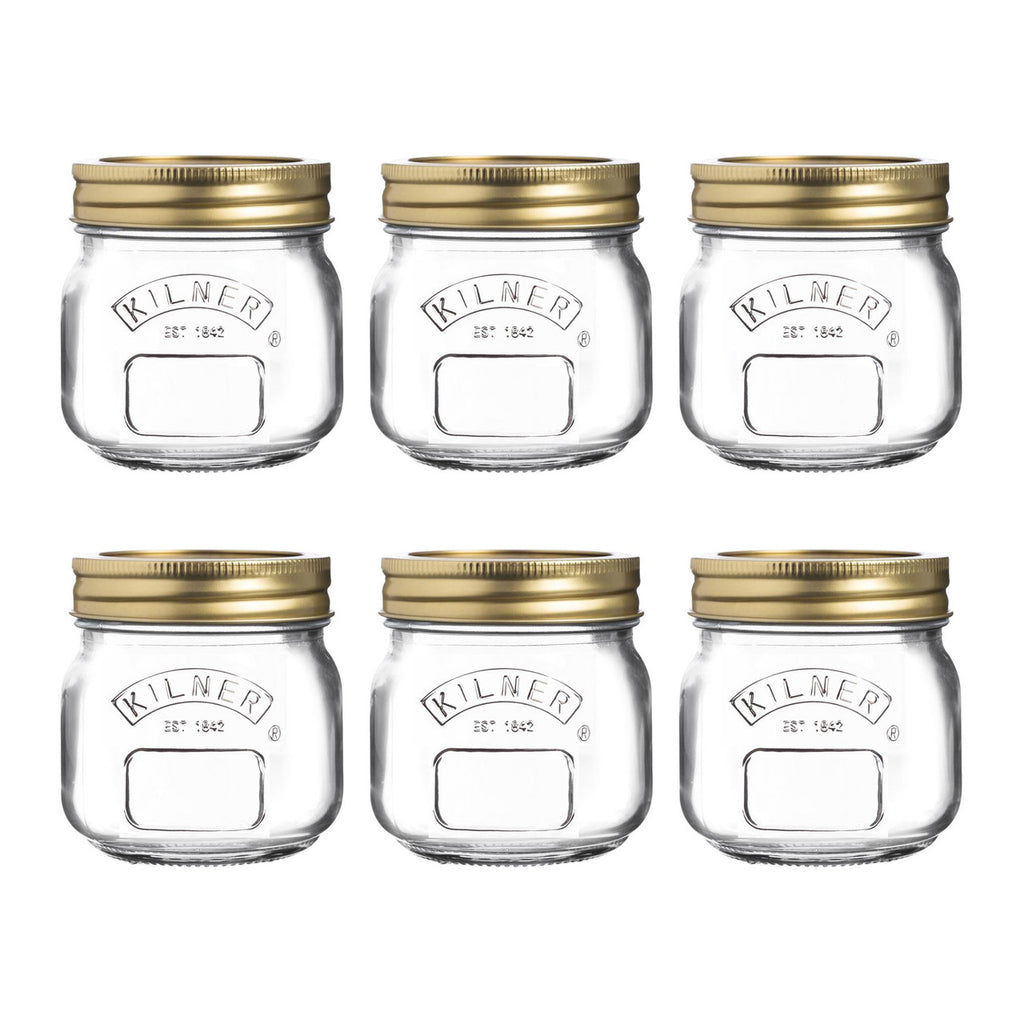 Set of six Kilner jars with gold lids on a white background