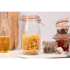 Glass jars with pasta and spices on a kitchen counter