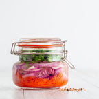 Jar of pickled vegetables with a white background