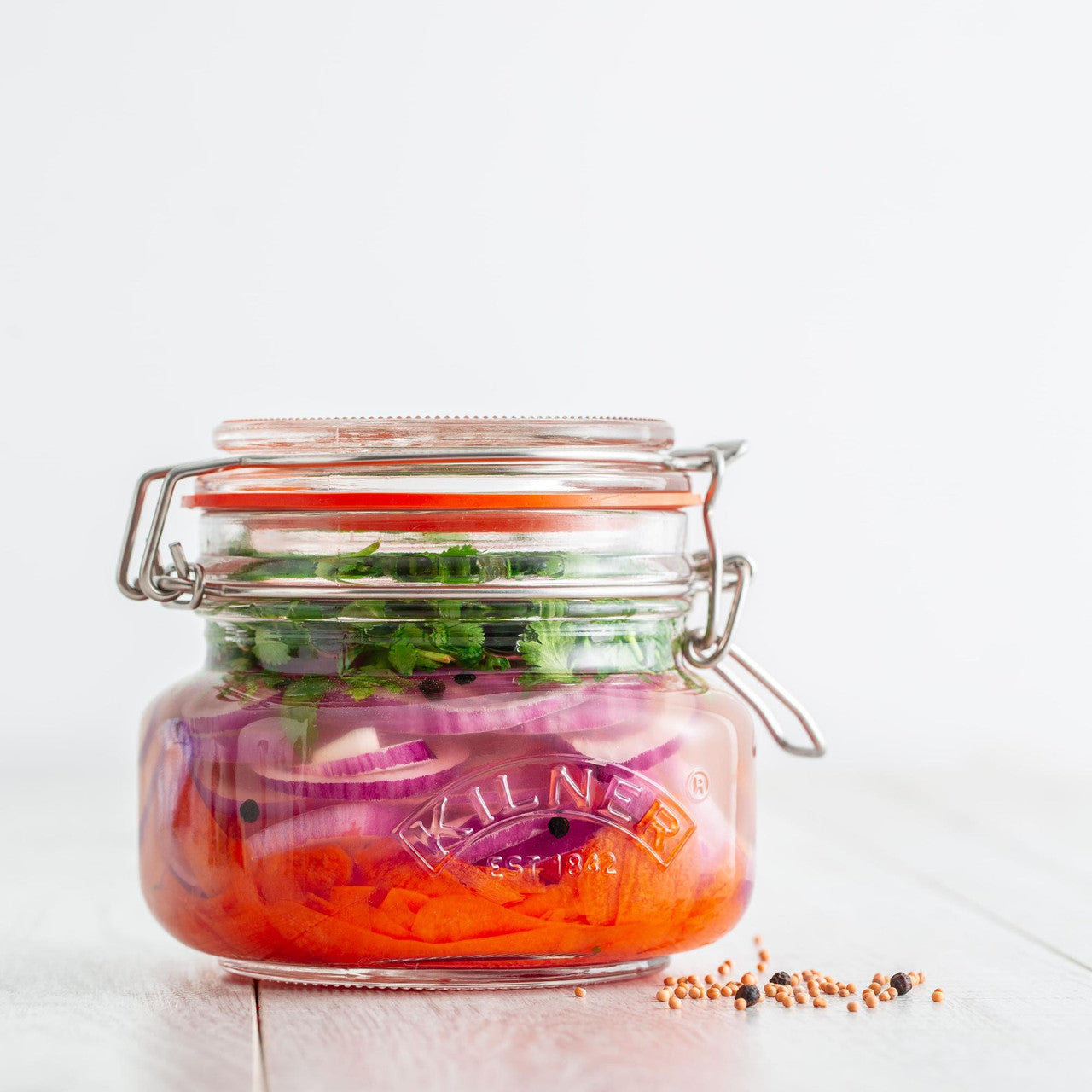 Jar of pickled vegetables with a white background