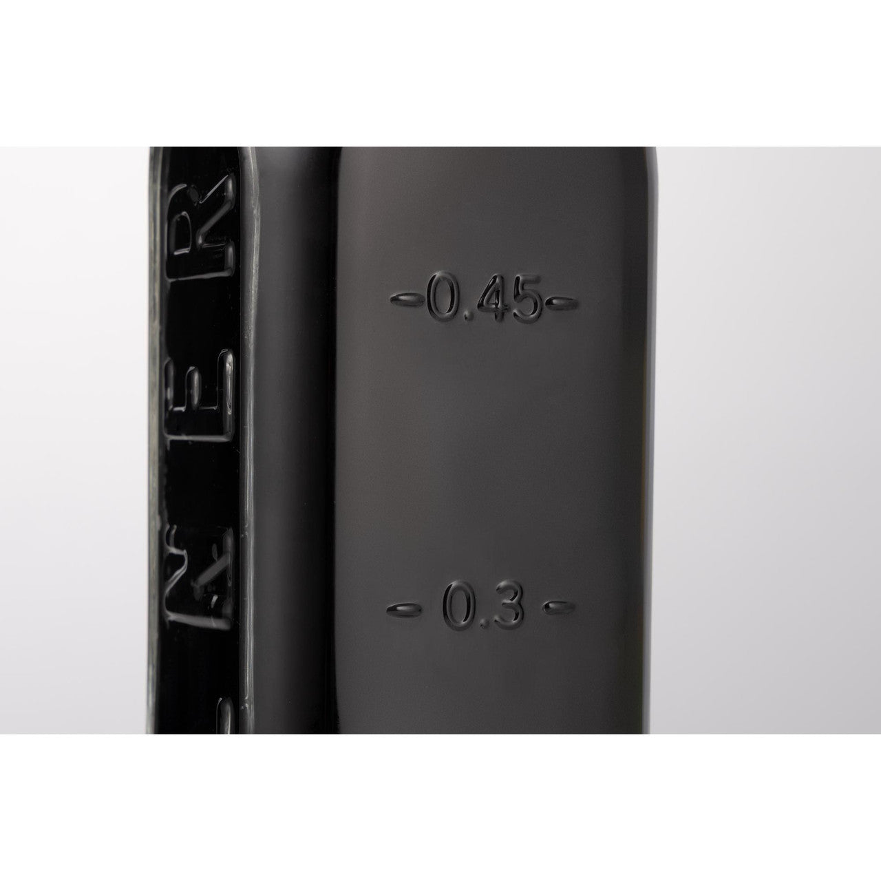 Close-up of a black firearm magazine with measurement markings on a white background