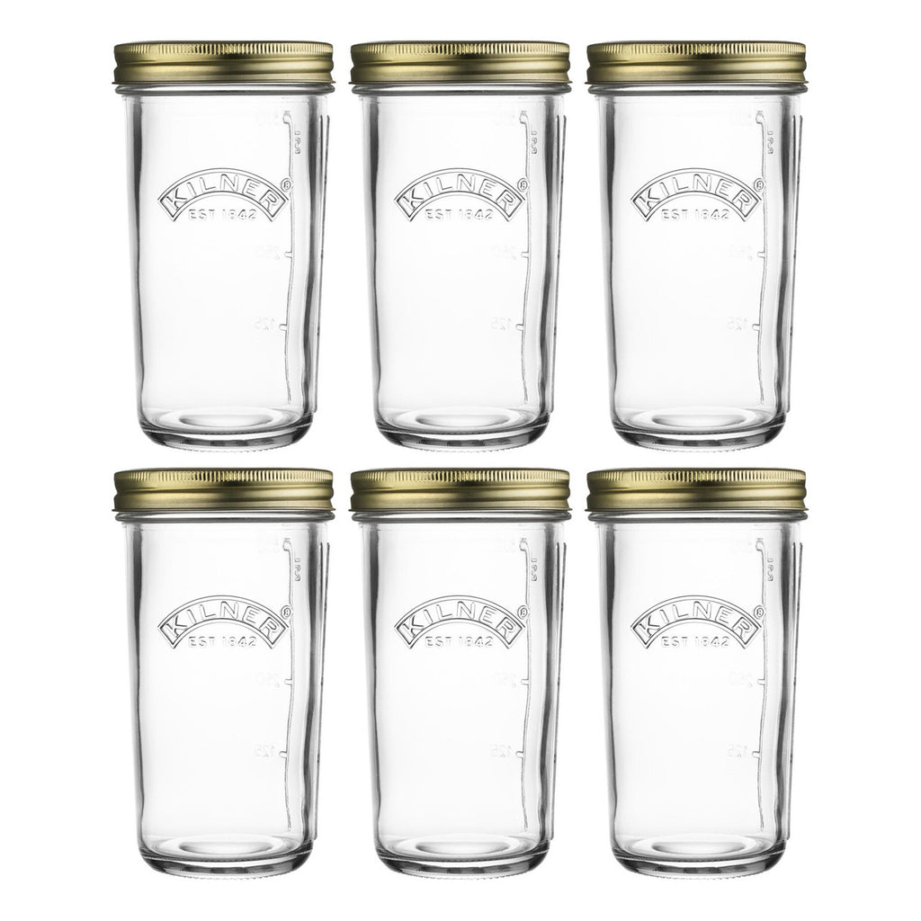 Set of six clear glass jars with gold lids on a white background