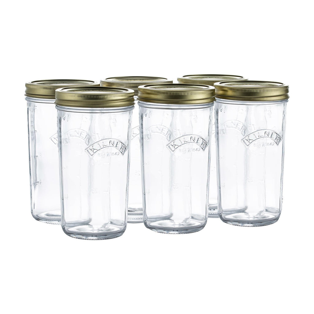 Set of six clear glass jars with gold lids on a white background