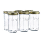 Set of six clear glass jars with gold lids on a white background