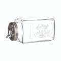 Clear glass beverage dispenser with metal spigot on a white background