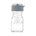 Clear glass bottle with a gray silicone lid on a white background